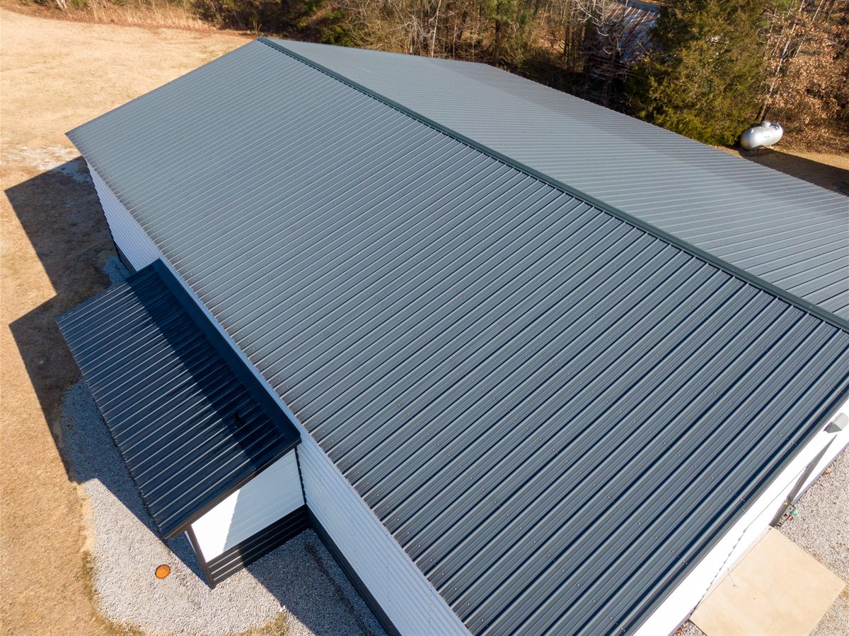 Aerial view of a newly sheeted grey metal roof on a farm building